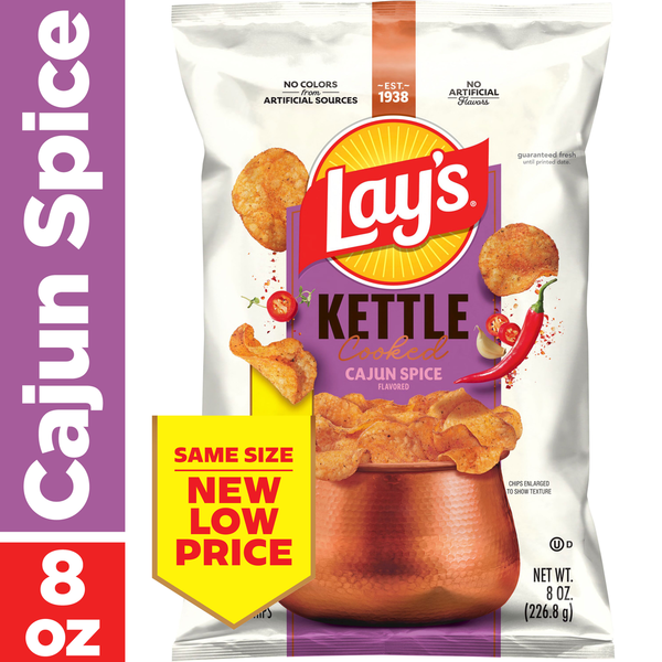 Lay's Kettle Cooked Cajun Spice flavored potato chips packaging with promotional text.