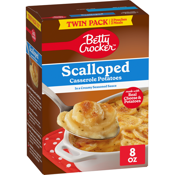 Box of Betty Crocker Scalloped Casserole Potatoes with a spoonful of potatoes on a white background
